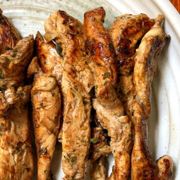Greek seasoned chicken tenders on plate