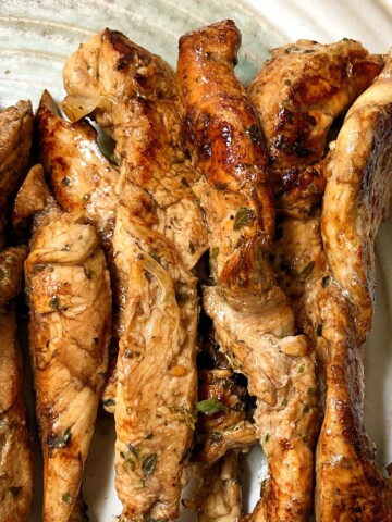 Greek seasoned chicken tenders on plate
