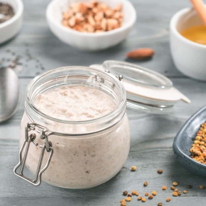 Overnight oats in glass jar with bowls of toppings