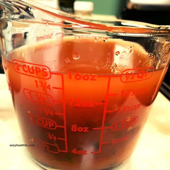 measuring cup with water and salsa