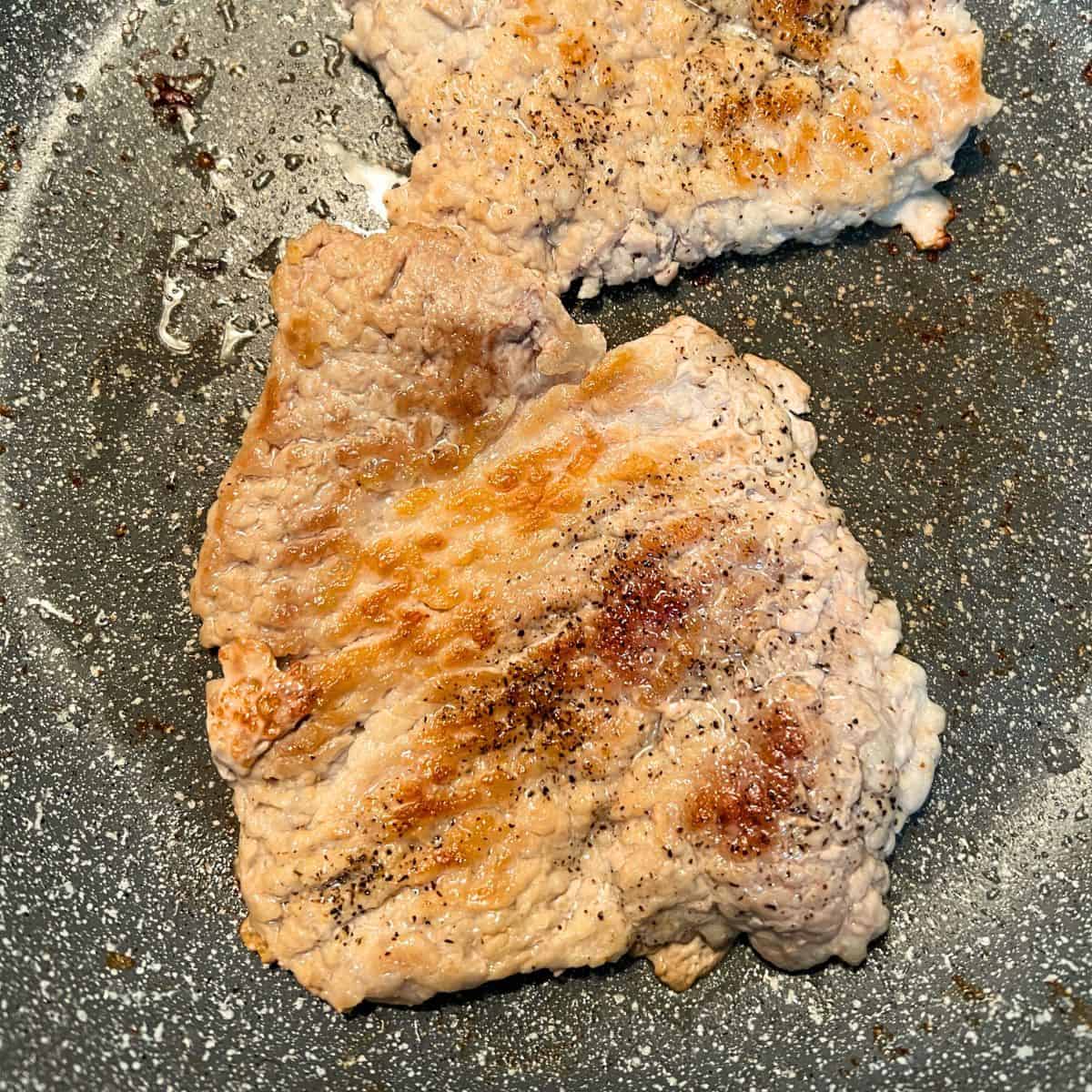 browned pork chops in skillet
