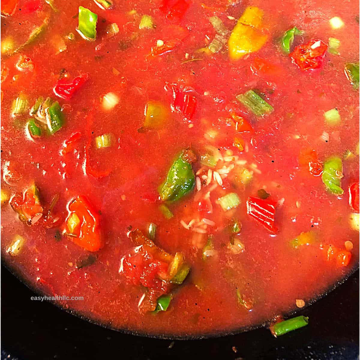 ingredients for spanish rice in skillet ready to be steamed