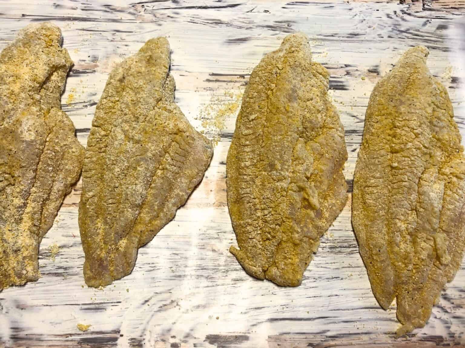 breaded catfish on a pan ready fro air fryer