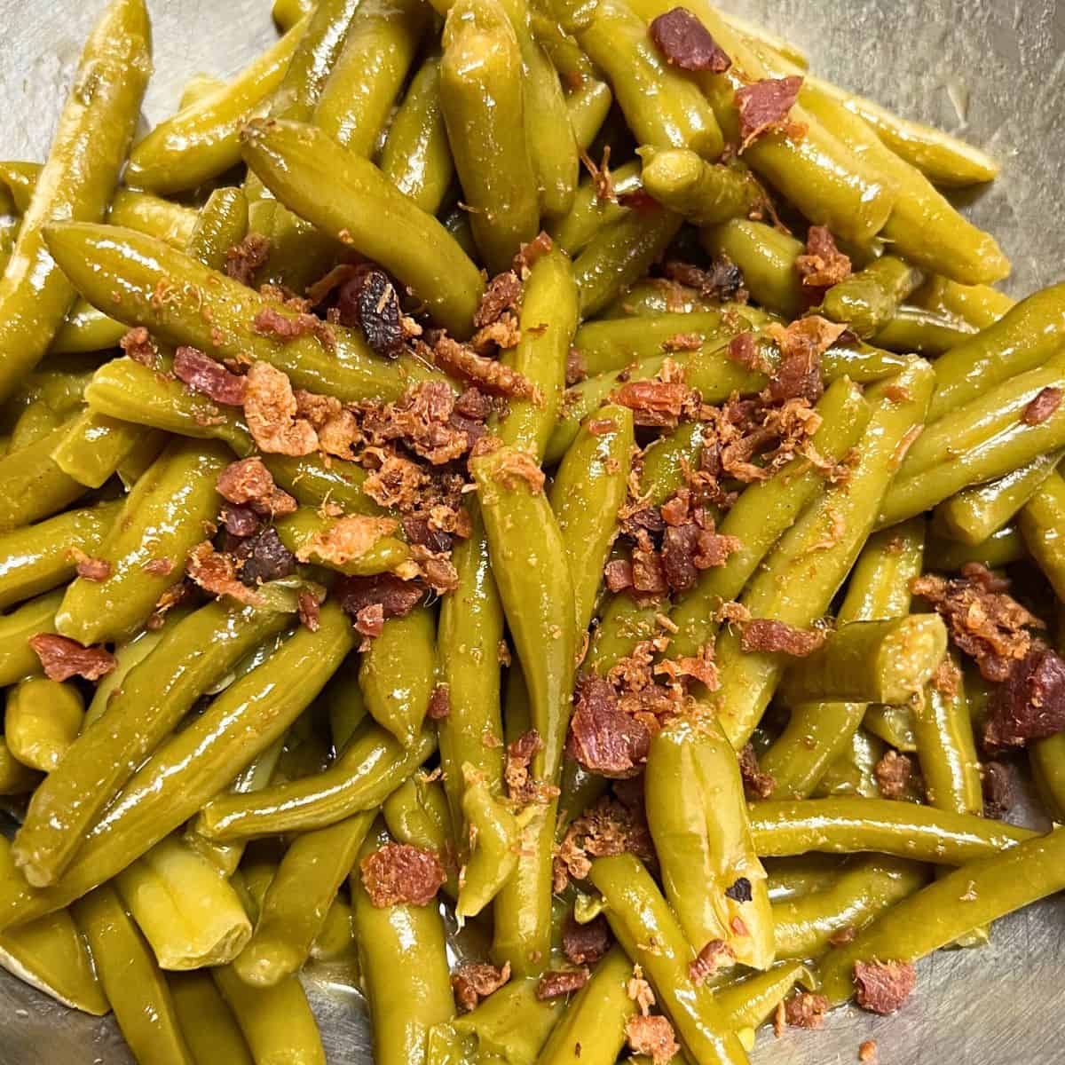Green beans with bacon bits on top.