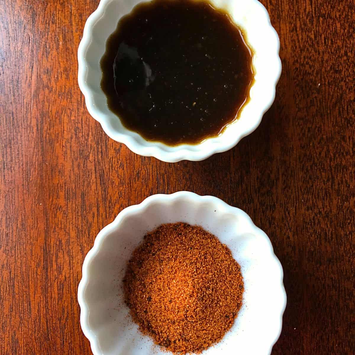 2 white bowls containing rotisserie seasoning and korean bbq sauce