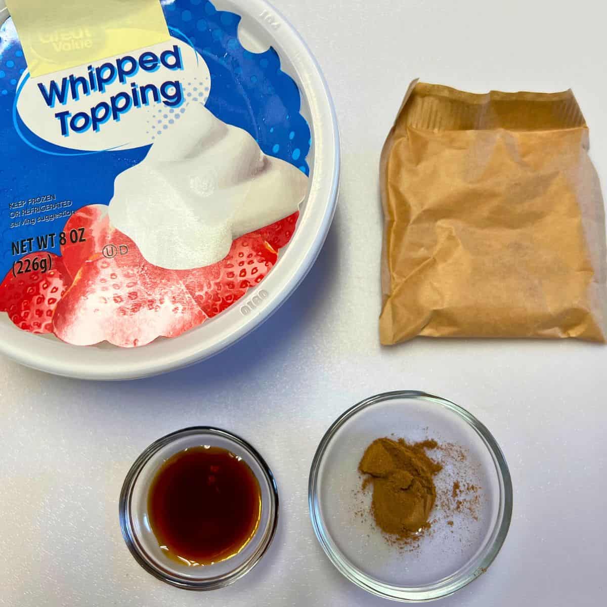 Ingredients for pumpkin fluff on white board.