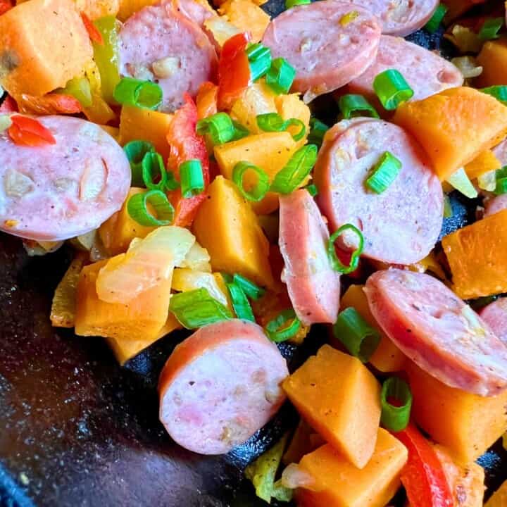 sweet potatoes, sliced sausage and peppers and onions in skillet 