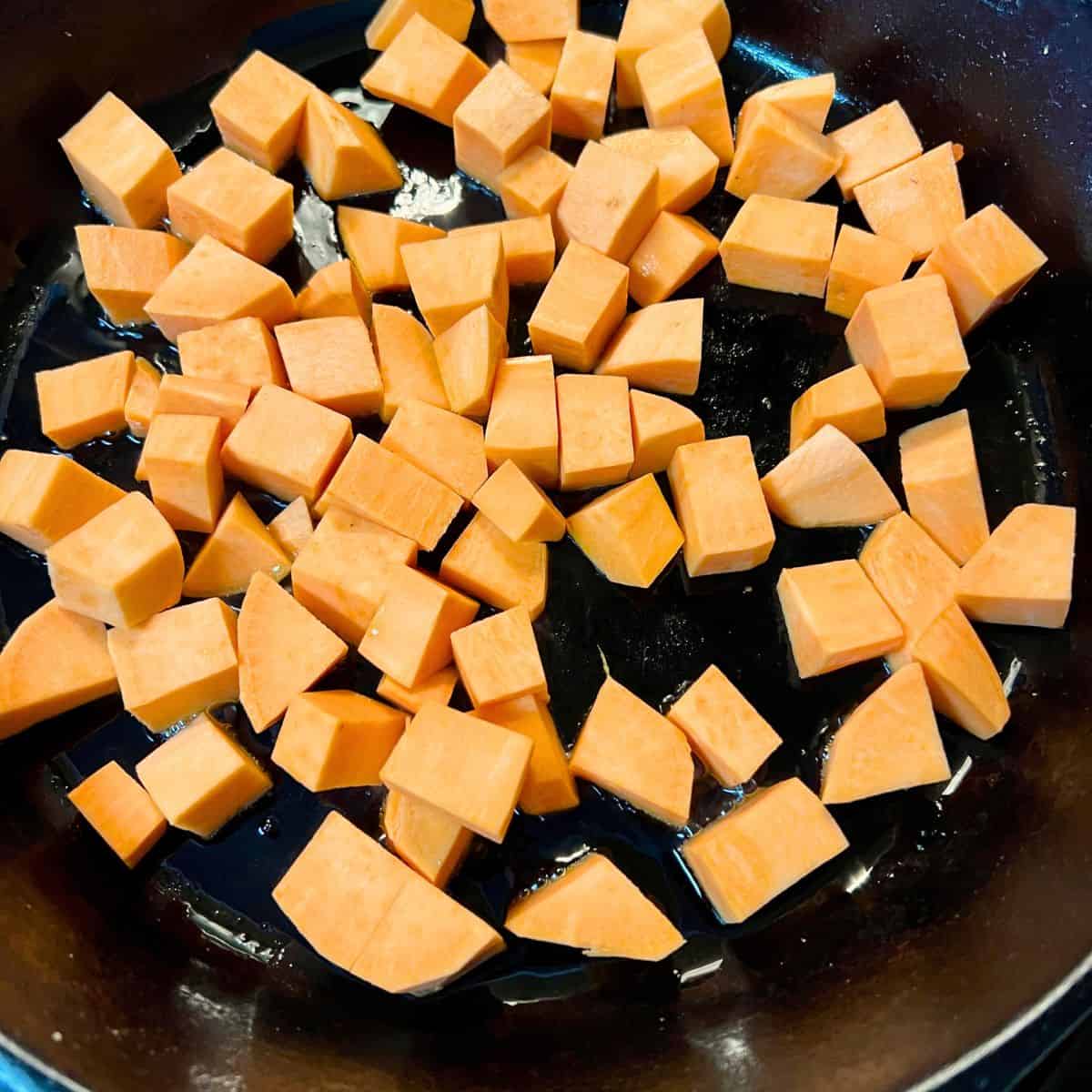 Diced sweet potatoes in skillet