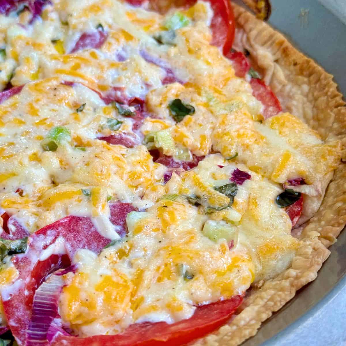 Tomato pie in crust with cheese and tomatoes