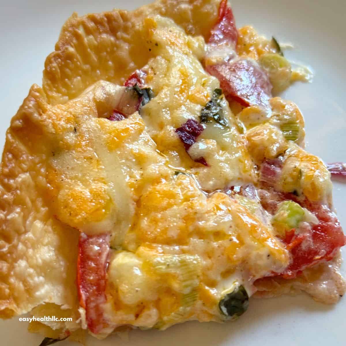 Slice of tomato pie on white plate.