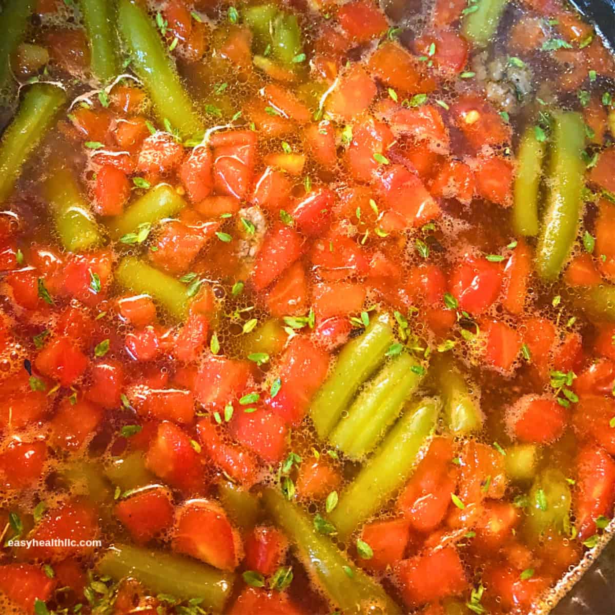 tomatoes and green beans in soup pot