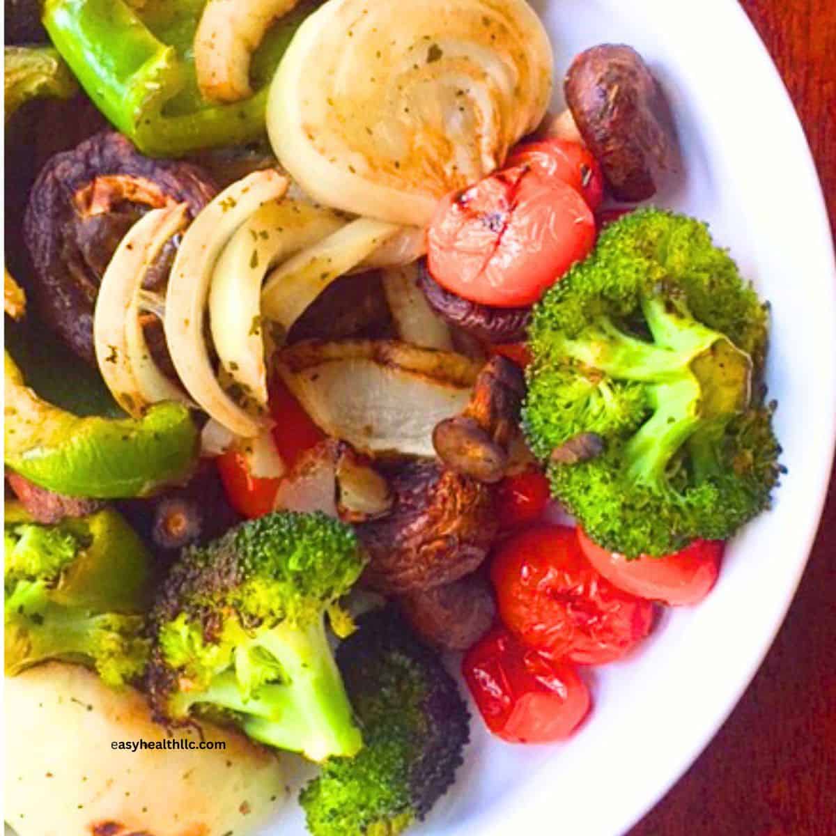 Grilled vegetables on white plate: Onions, broccoli, mushrooms and peppers